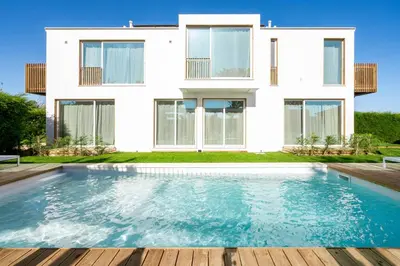 a house with a swimming pool in front of a house at Casa Vica - Sagres Apartments in Sagres