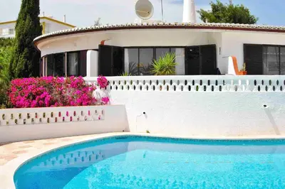 a house with a swimming pool in front of a house at Casa Catryn in Luz