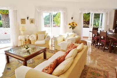 a living room with white furniture and a table at Casa Catryn in Luz