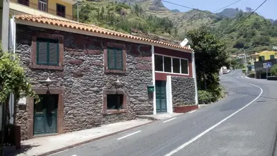 a stone building on the side of a road at Refúgio do Vale in Ribeira Brava
