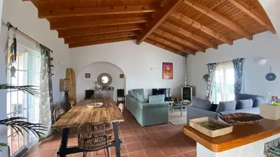 a living room with a table and a couch at Arrifana Beach Break in Aljezur