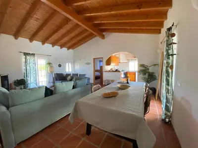 a living room with a table and a couch at Arrifana Beach Break in Aljezur
