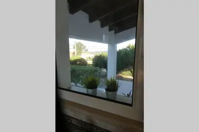 a window of a house with potted plants on it at Casa Colina, walking distance to Arrifana Beach in Aljezur