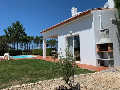 a villa with a view of the garden and pool at Casa Colina, walking distance to Arrifana Beach in Aljezur
