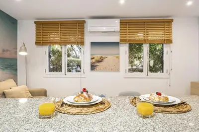two plates of food on a table with two glasses of orange juice at Funchal Tropical Apartments by Homie in Funchal