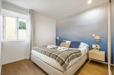 a bedroom with a large bed and a window at Funchal Tropical Apartments by Homie in Funchal