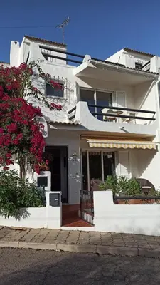 a white building with flowers in front of it at Casa da Torre Alta in Lagos