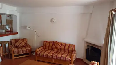 a living room with two chairs and a fireplace at Casa da Torre Alta in Lagos