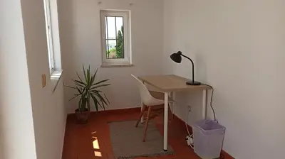 a desk with a lamp and a chair in a room at Casa da Torre Alta in Lagos