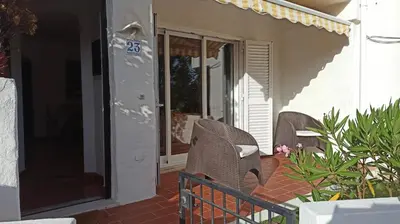 a porch with two wicker chairs on a patio at Casa da Torre Alta in Lagos