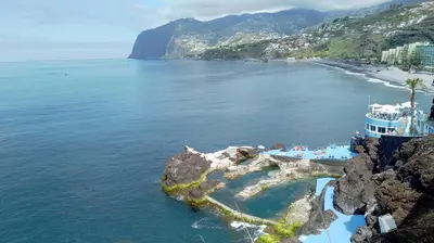 an island in the ocean with a cruise ship at Green Park Ajuda Apartment in Funchal