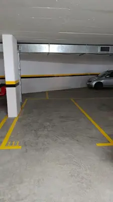 a parking garage with a car parked in a parking lot at Green Park Ajuda Apartment in Funchal