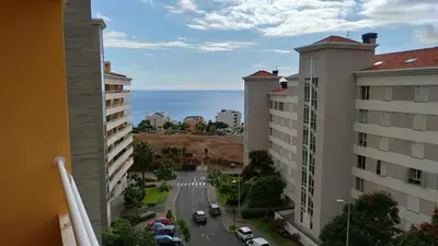 a view of a street between two buildings and the ocean at Green Park Ajuda Apartment in Funchal