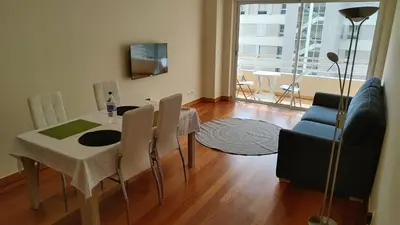 a living room with a table and chairs and a window at Green Park Ajuda Apartment in Funchal