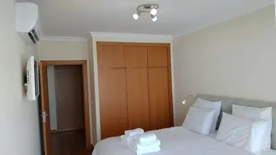 a bedroom with a bed with towels on it at Green Park Ajuda Apartment in Funchal