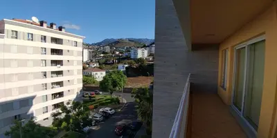 a balcony of a building with a view of a city at Green Park Ajuda Apartment in Funchal