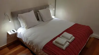 a bedroom with a large bed with two towels on it at Green Park Ajuda Apartment in Funchal