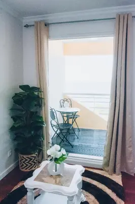 a living room with a table with a vase of flowers at Dorisol Vista Formosa by rentallido in Funchal