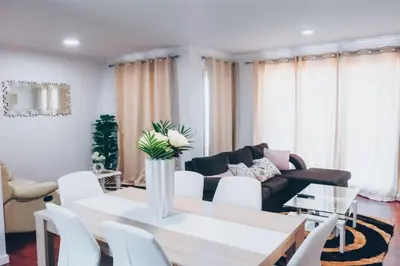 a living room with a table and white chairs at Dorisol Vista Formosa by rentallido in Funchal