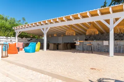 a pavilion with chairs and a bar in a patio at Vida Boa Lodge in Lagos