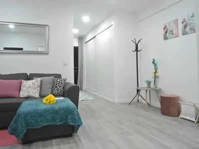 a living room with a couch and a table at Town Apartment in Funchal