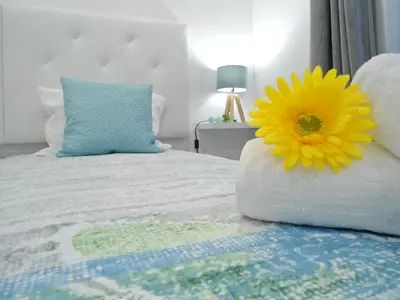 a bedroom with a bed with a yellow flower on it at Town Apartment in Funchal