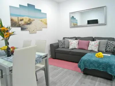 a living room with a couch and a table at Town Apartment in Funchal
