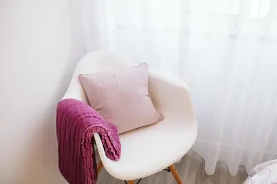 a white chair with a purple blanket on it at Os Fragosinhos by Amazing Madeira in Funchal