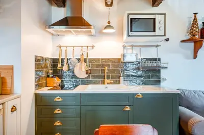 a kitchen with a sink and a microwave at Casa Da Muda in Ponta do Pargo