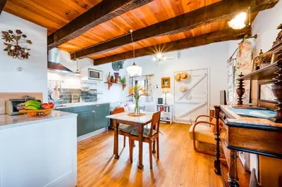a kitchen with wooden ceilings and a wooden table at Casa Da Muda in Ponta do Pargo