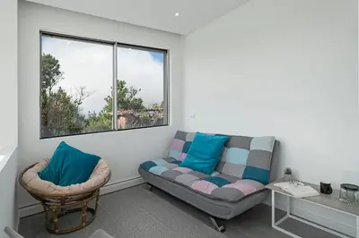 a living room with a couch and two chairs at Casa da Maloeira by An Island Apart in Fajã da Ovelha
