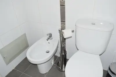 a bathroom with a toilet and a sink at Design Gardens, a Home in Madeira in Funchal
