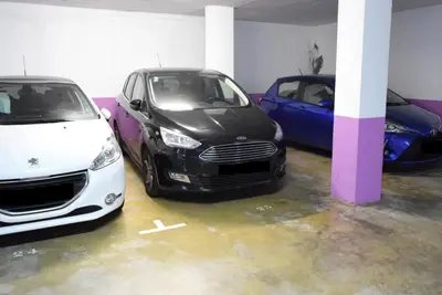 two cars are parked in a parking lot at Design Gardens, a Home in Madeira in Funchal