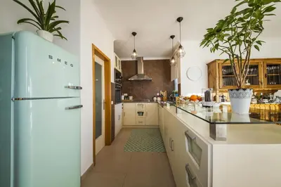 a kitchen with white cabinets and a refrigerator at D09 - Porto de Mos Luxury Villa in Lagos