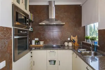 a kitchen with a sink and a stove top oven at D09 - Porto de Mos Luxury Villa in Lagos