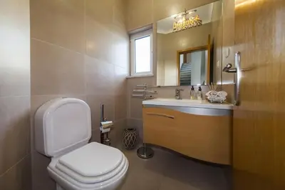 a bathroom with a toilet and a sink and a mirror at D09 - Porto de Mos Luxury Villa in Lagos