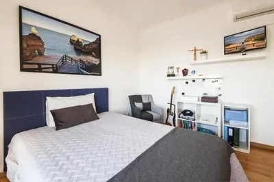 a bedroom with a bed and a chair in it at D09 - Porto de Mos Luxury Villa in Lagos