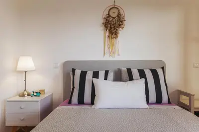 a bedroom with a bed with a clock on the wall at D09 - Porto de Mos Luxury Villa in Lagos