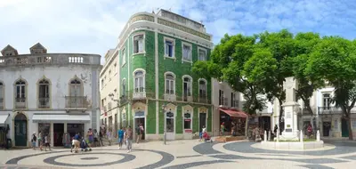 a green building on a street in a city at D09 - Porto de Mos Luxury Villa in Lagos
