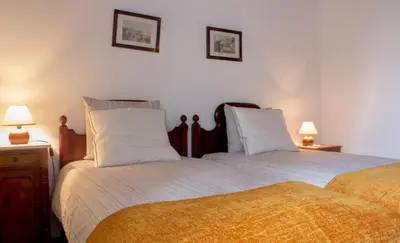 two beds sitting next to each other in a bedroom at Vila Joaninha in Santo da Serra