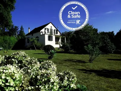 a white house with a sign that says clean and safe at Vila Joaninha in Santo da Serra