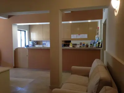 a living room with a couch and a kitchen at Vilamar in Luz