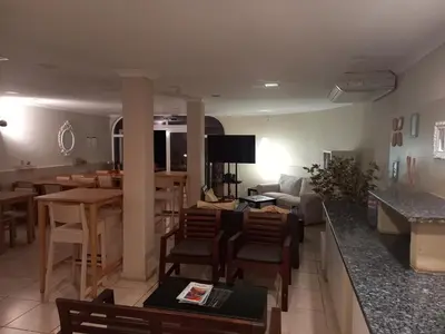 a living room with a bar and a dining room at Vilamar in Luz