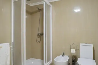 a bathroom with a shower and a toilet and a sink at Machico Beach, a Home in Madeira in Machico