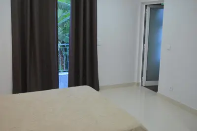 a bedroom with a bed and a large window at Descobrir Madeira in Gaula