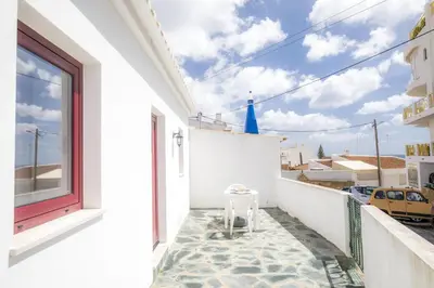 a white balcony with a stool on the floor at C14 - Casa da Luz in Luz