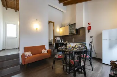 a living room with a table and a couch and a kitchen at C14 - Casa da Luz in Luz