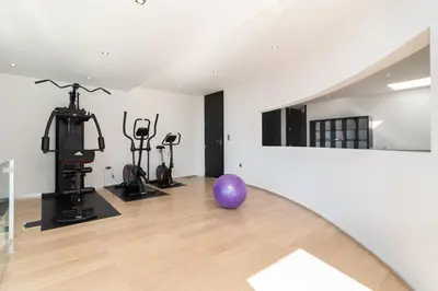 a room with a gym with a purple ball on the floor at Luxo & Conforto in Calheta