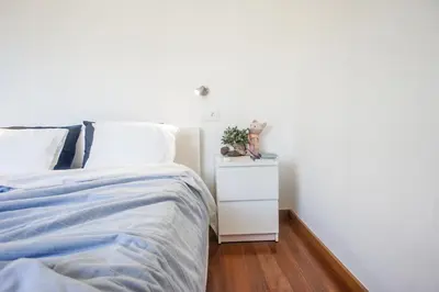 a bedroom with a bed and a night stand with a plant at Trendy Apartments in Funchal