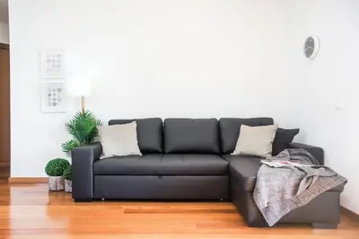 a black couch sitting in a living room at Trendy Apartments in Funchal